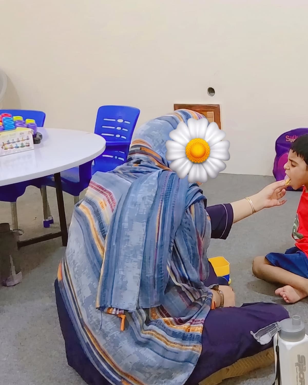 A teacher leading a small group activity at the table