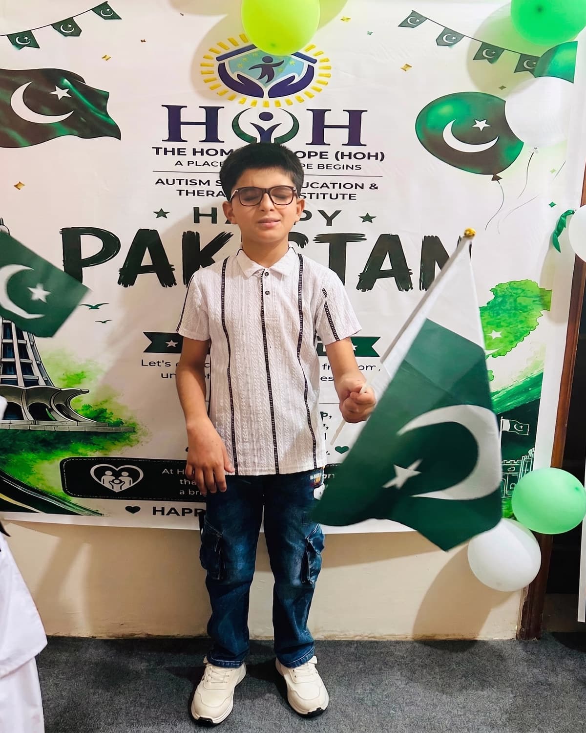 A student in front of the Home of Hope Independence Day banner