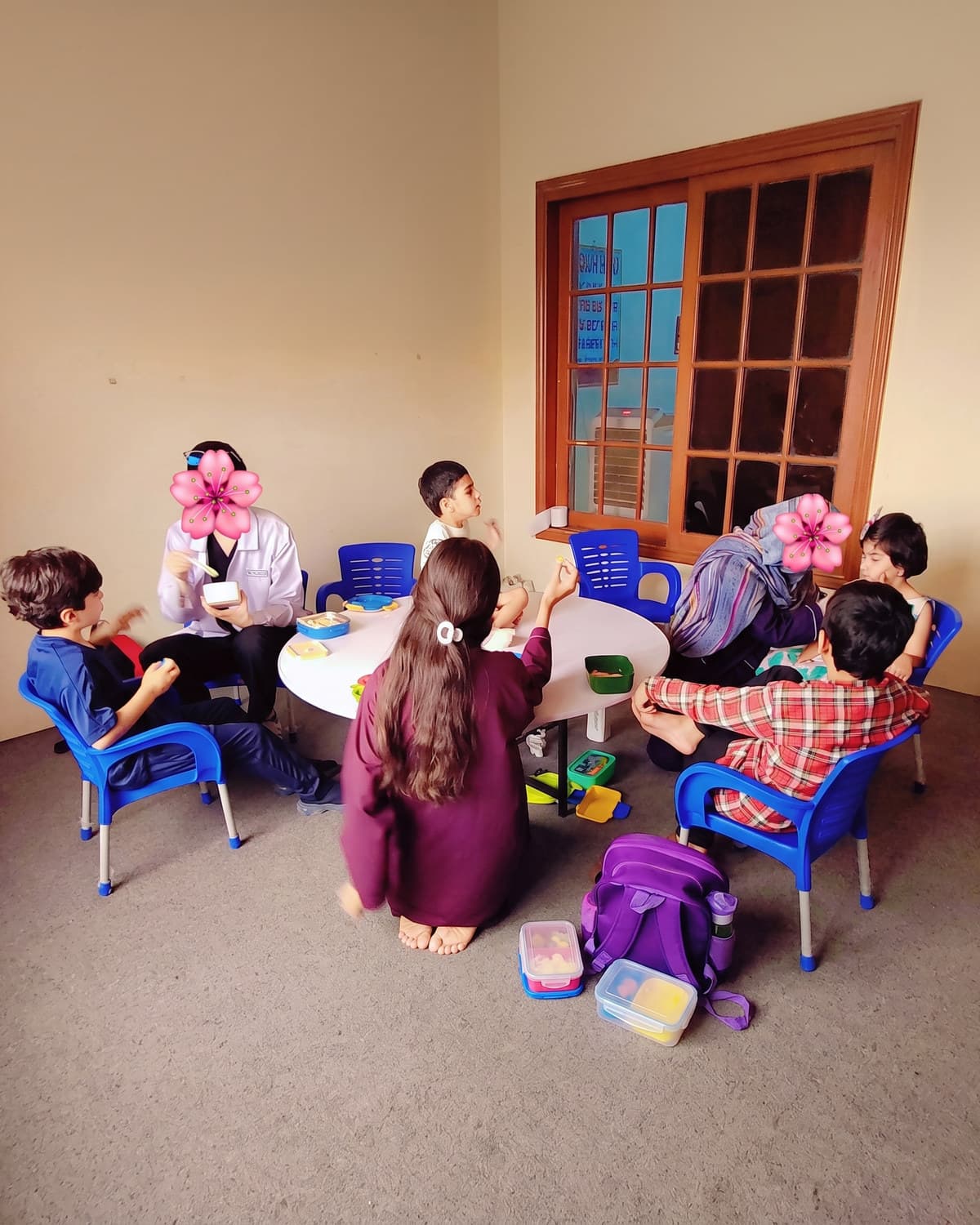 A classroom of children at their desks with their teacher