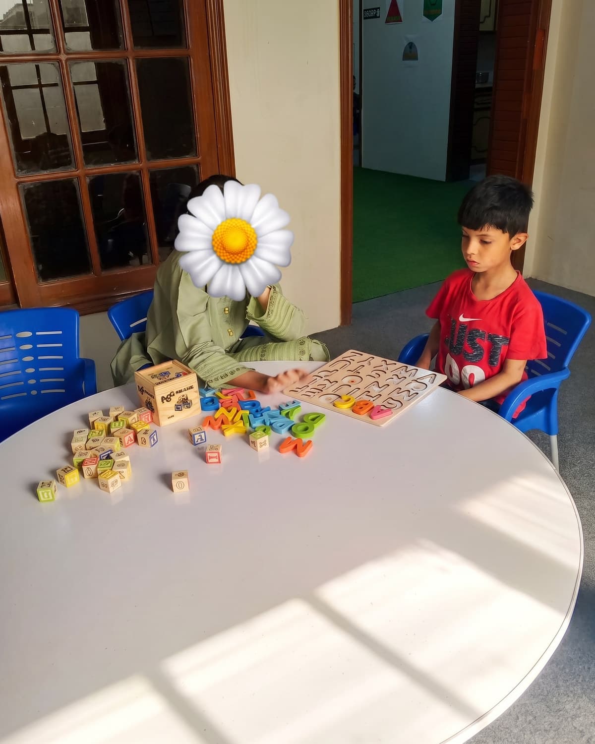 Children matching coloured tiles in a sunlit classroom