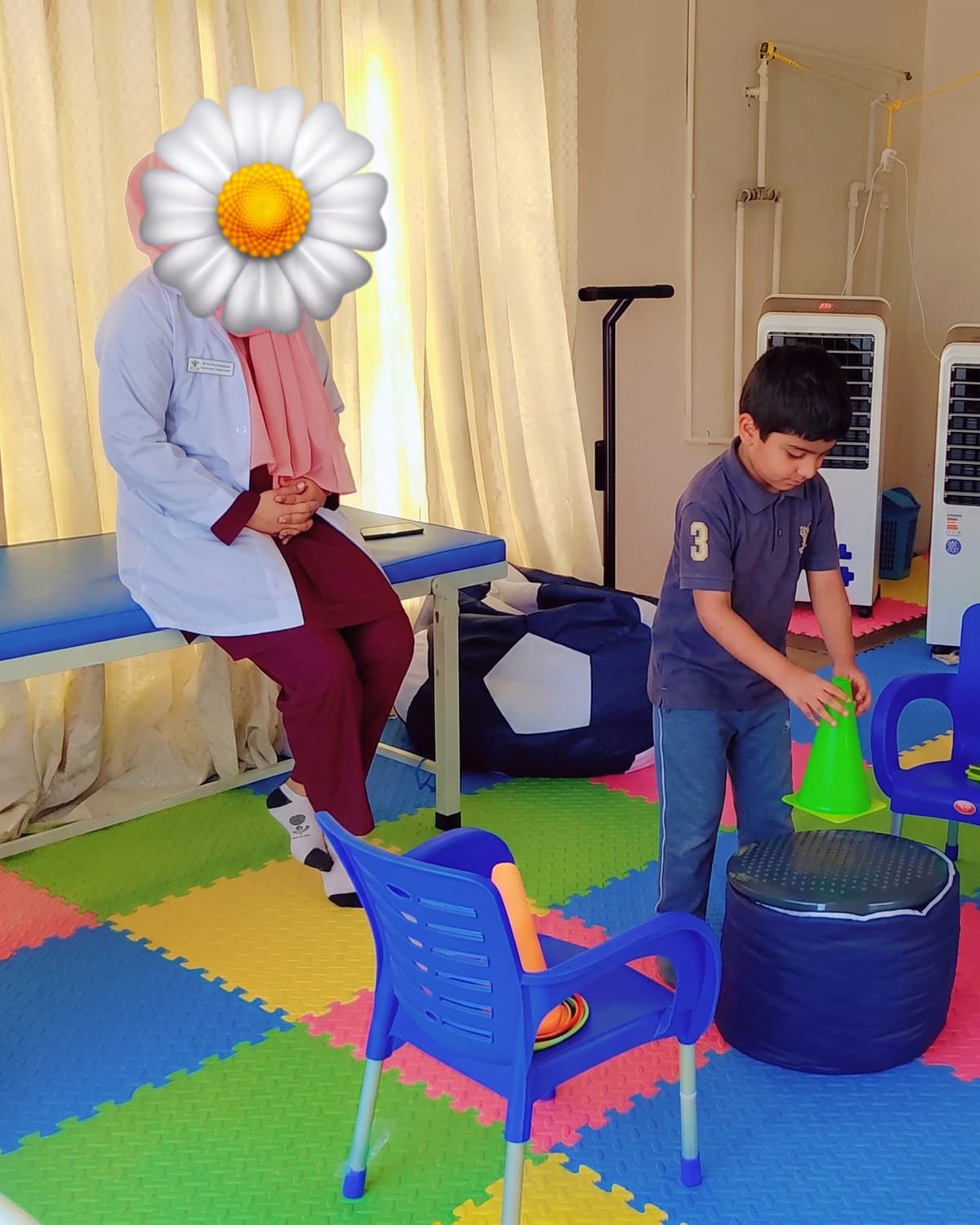A child stepping across soft play equipment in the sensory gym