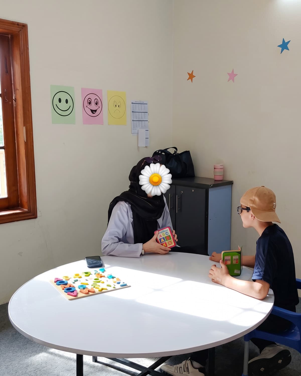 A teacher and child working one to one at the table