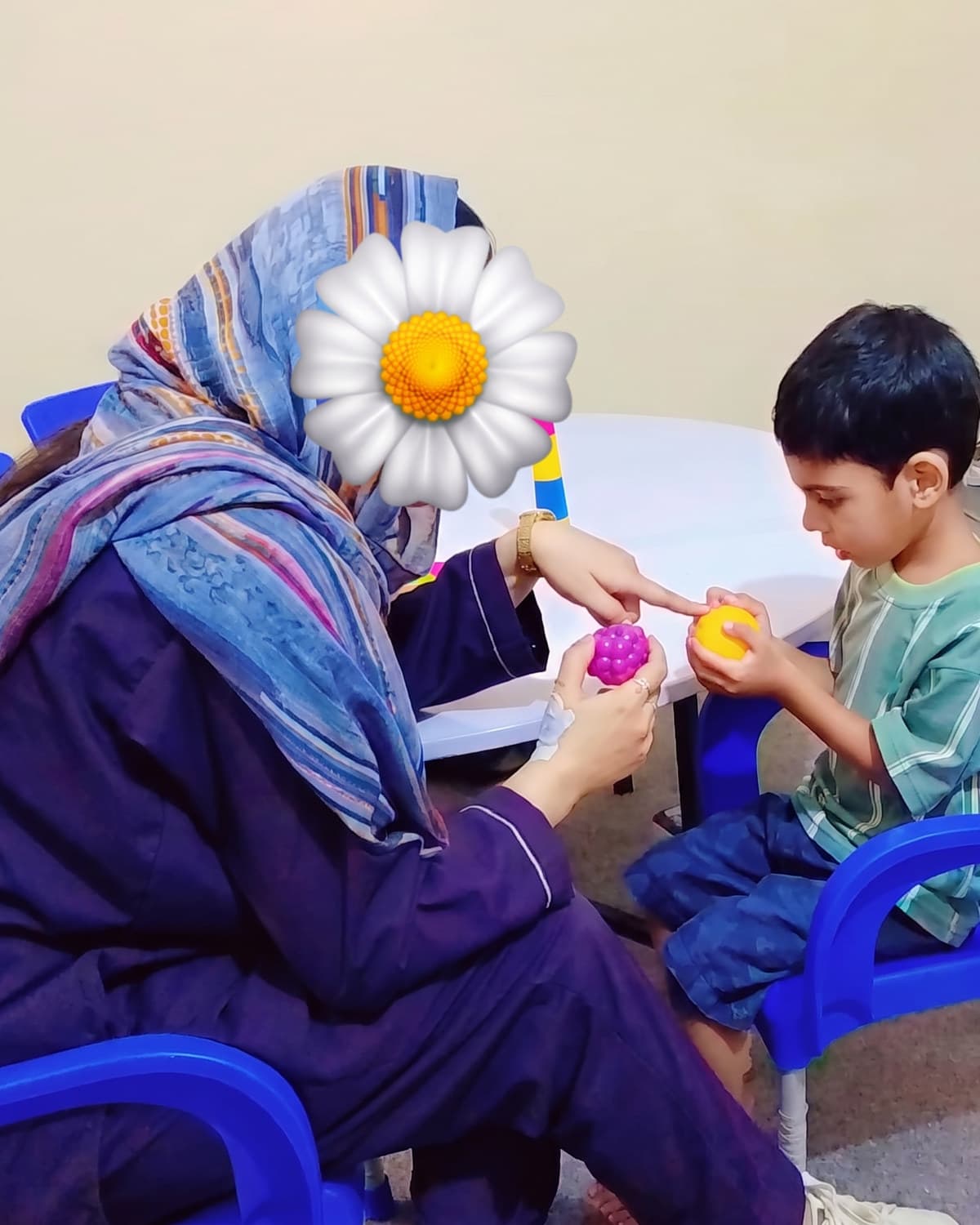A teacher guiding a child through a stacking activity