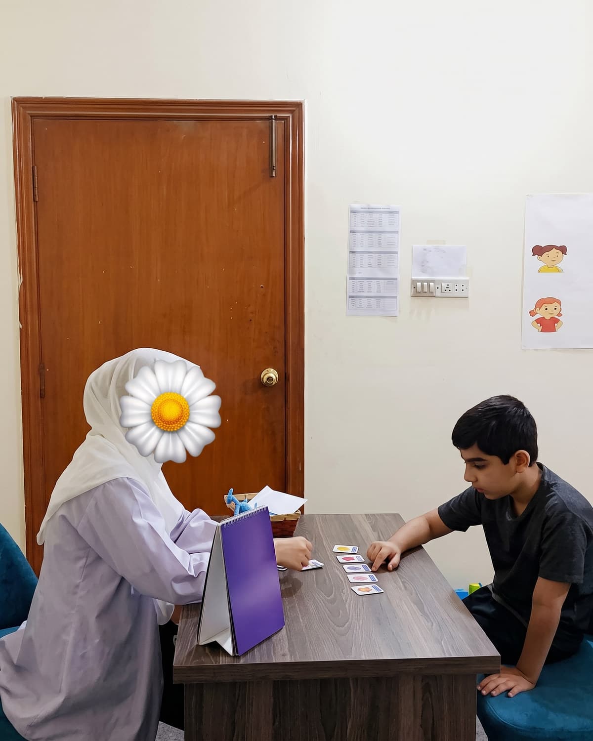 A teacher and child side by side at a one-to-one sorting task